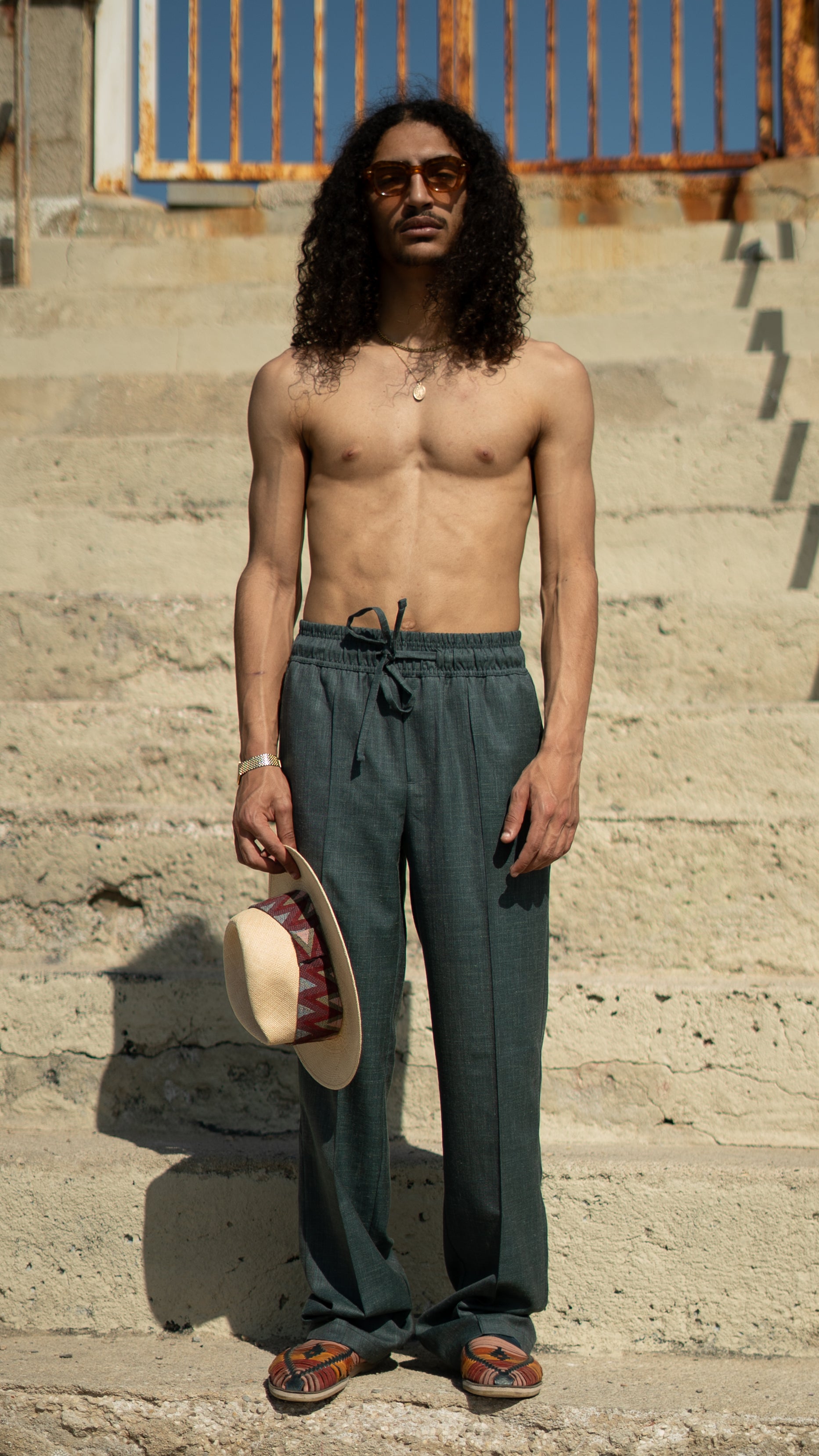 Man_Long_Hair_wearing_green Super 110ss Wool Drawstring trousers - Holding a Pineapple