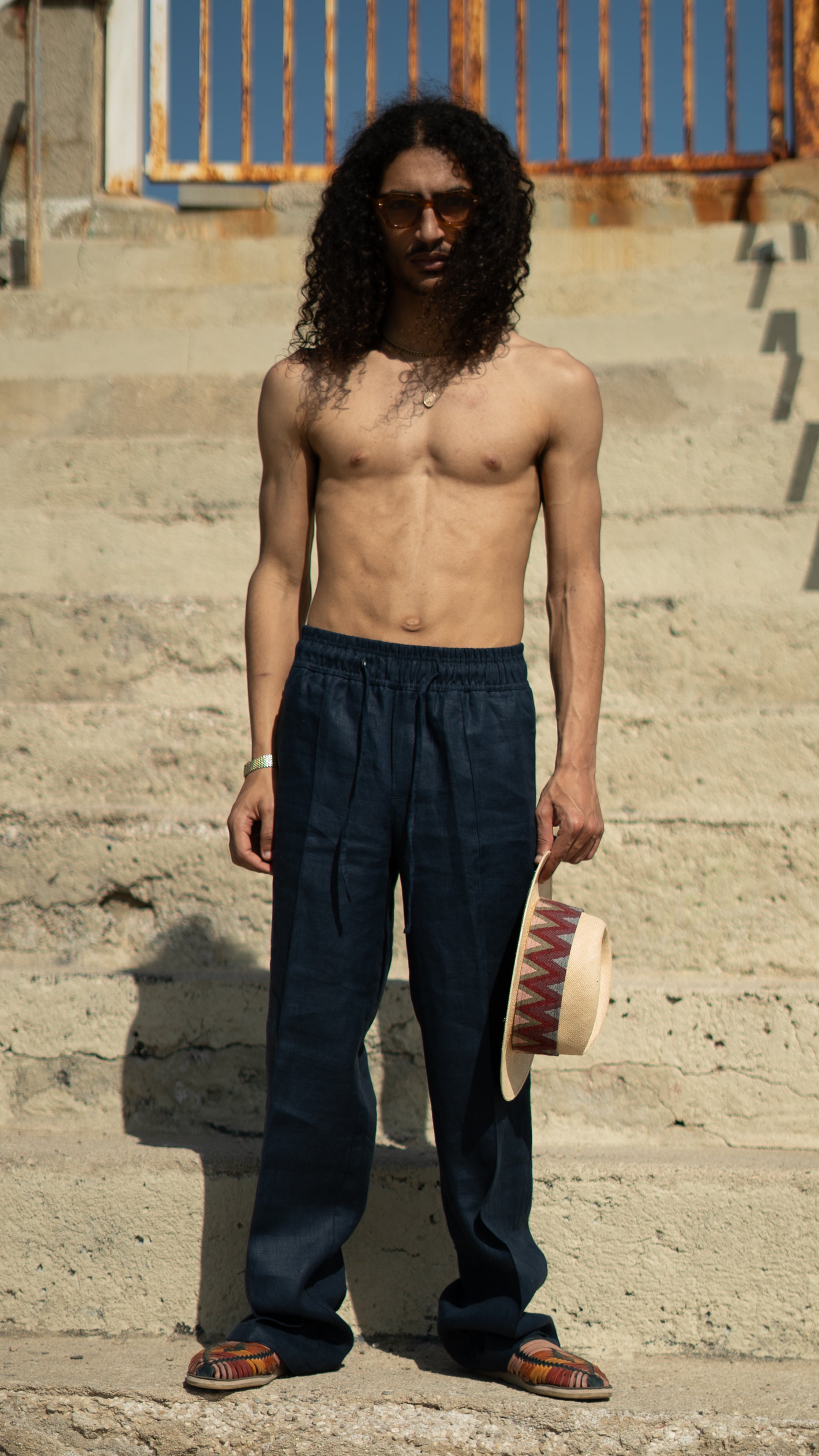 Man_Long_Hair_wearing_Blue Linen Drawstring trousers - Holding a Pineapple