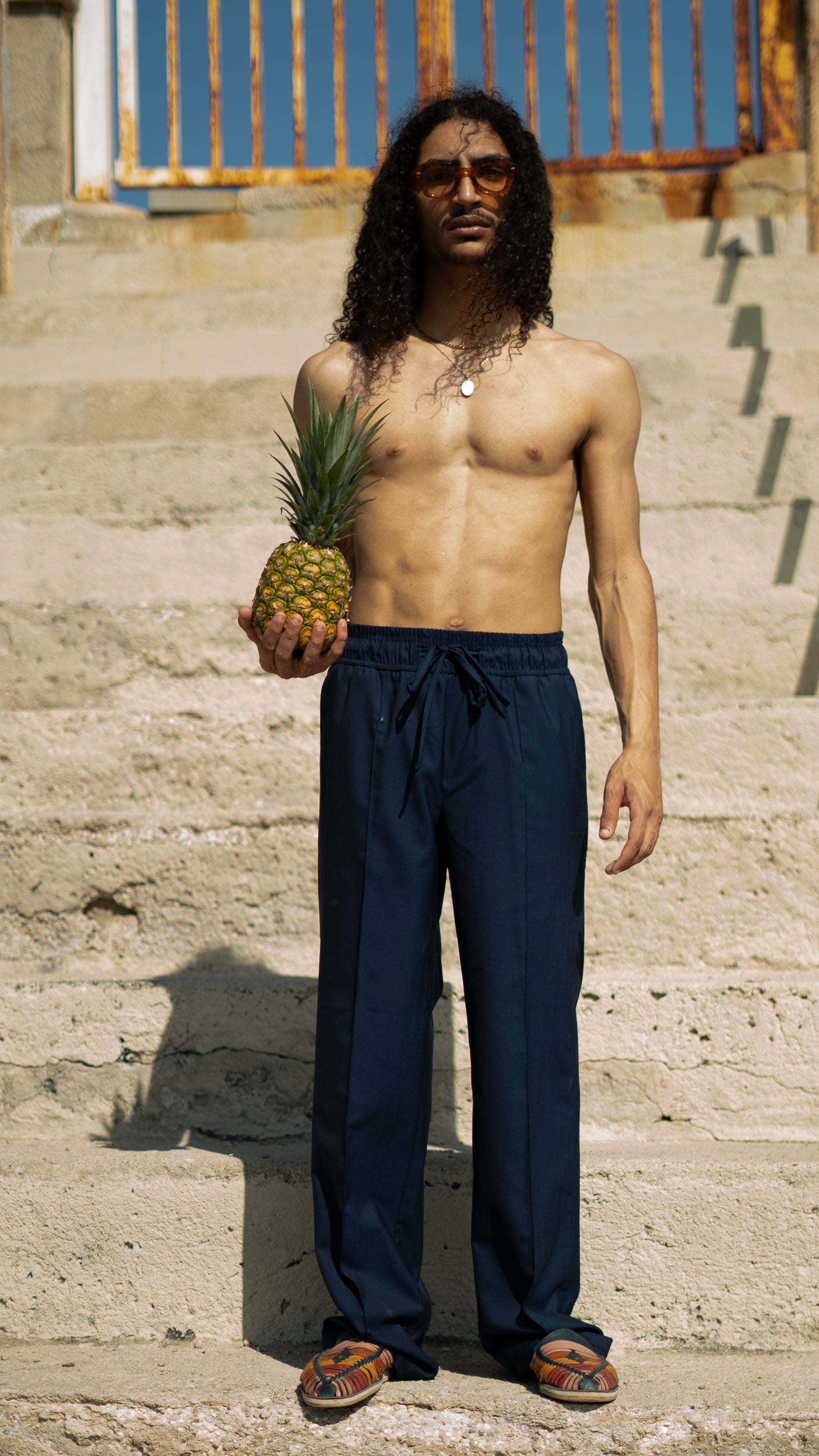 Man_Long_Hair_wearing_Navy Blue Super 110ss Wool Drawstring trousers - Holding a Pineapple
