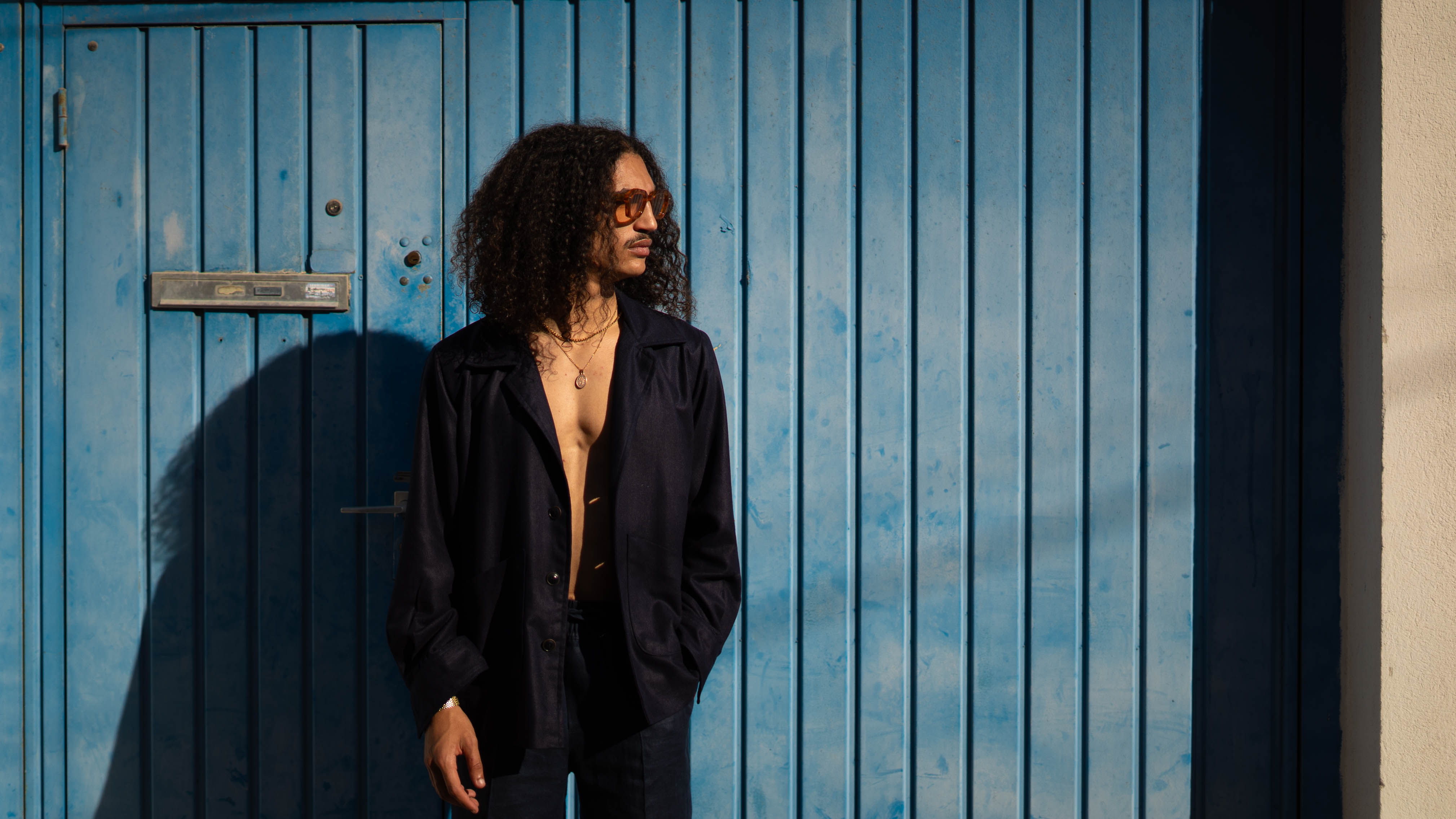 QUINTOPIANO_-_STREET PHOTOGRAPHY Model wearing Navy silk Overshirt with blue background 2